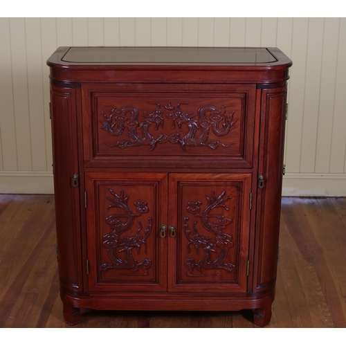 61 - A CHINESE ROSEWOOD COCKTAIL CABINET the hinged lid containing compartments above a pair of cupboards... 