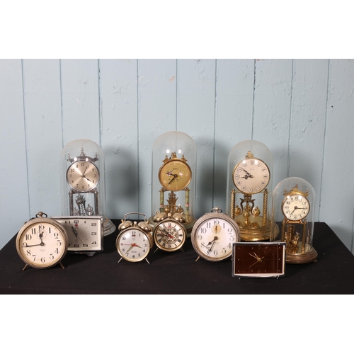 618 - A COLLECTION OF VARIOUS CLOCKS to include four brass dome clocks, etc.