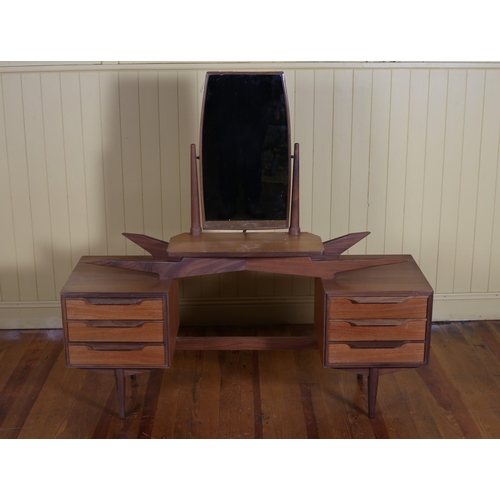 623 - A VINTAGE TEAK DRESSING TABLE the superstructure with swivel mirror above a moulded shelf flanked on... 