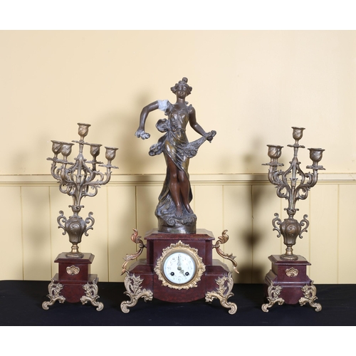 68 - A VINTAGE GILT SPELTER AND MARBLE CLOCK GARNITURE the rectangular stepped case surmounted by a femal... 