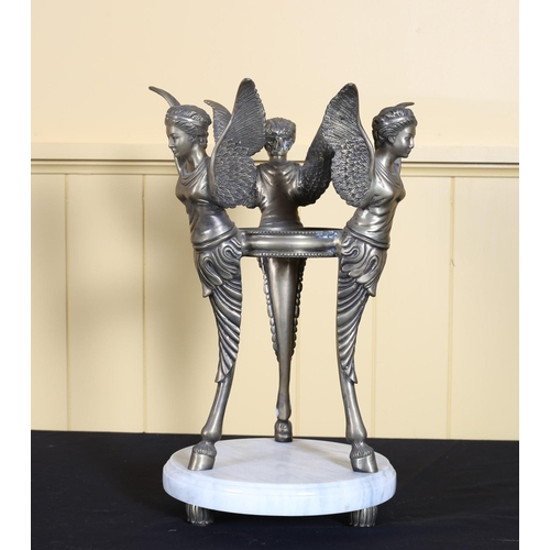 69 - A BRASS FIGURE ON MARBLE BASE the circular marble base supporting three winged figures joined by a c... 