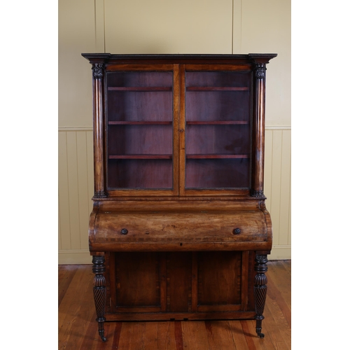 7 - A 19TH CENTURY MAHOGANY CYLINDER FRONT DESK the superstructure with glazed cupboards flanked on each... 