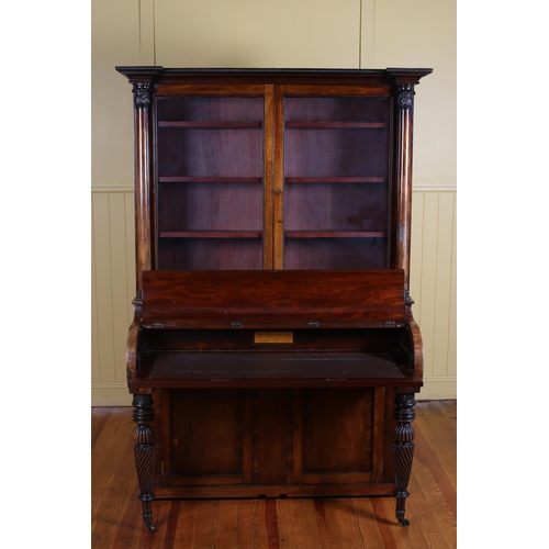 7 - A 19TH CENTURY MAHOGANY CYLINDER FRONT DESK the superstructure with glazed cupboards flanked on each... 