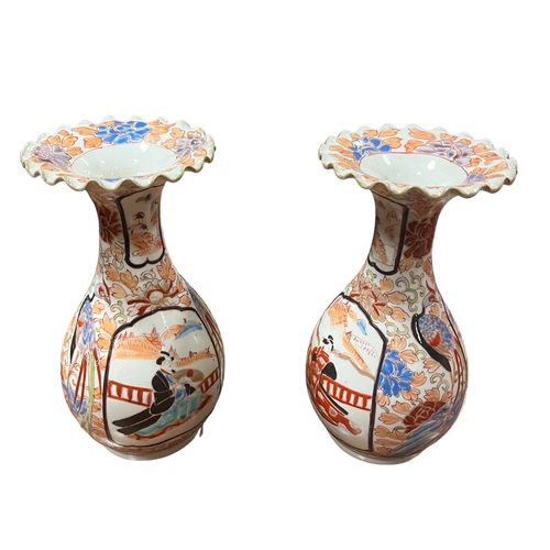 716 - A PAIR OF IMARI STYLE VASES each of baluster form the white, light pink and light blue ground decora... 