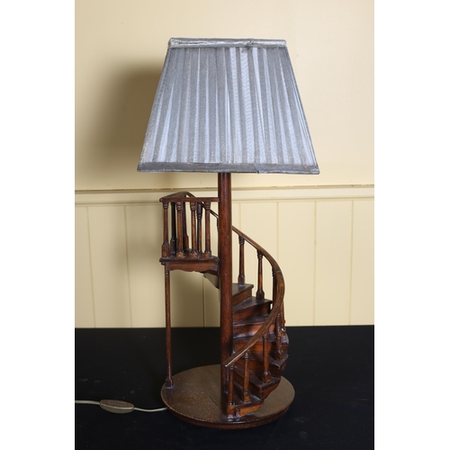 78 - A MAHOGANY TABLE LAMP in the form of staircase on a circular base with pleated shade 66cm (h)