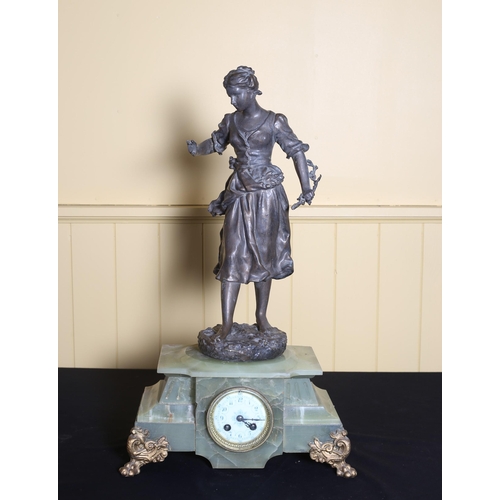 83 - A VINTAGE CONTINENTAL GREEN ONYX AND GILT SPELTER CLOCK surmounted by a female shown standing above ... 