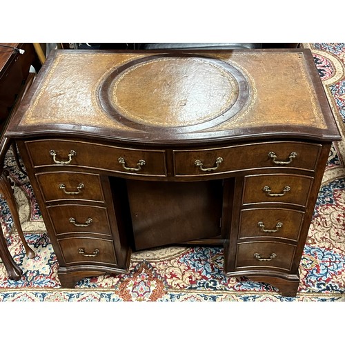 649 - A GEORGIAN STYLE MAHOGANY PEDESTAL DESK of serpentine outline with tooled leather writing surface ab... 