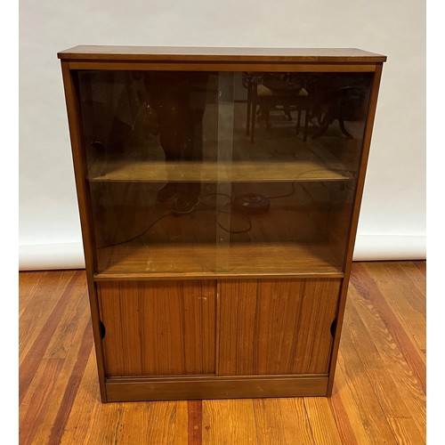 742 - A RETRO TEAK DISPLAY CABINET with glass sliding doors containing two shelves the base with sliding d... 