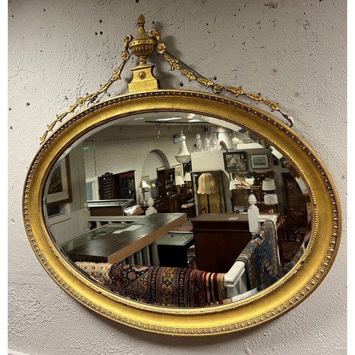 578 - AN ADAM DESIGN GILTWOOD AND GESSO MIRROR the oval plate within an egg and dart and beadwork frame wi... 