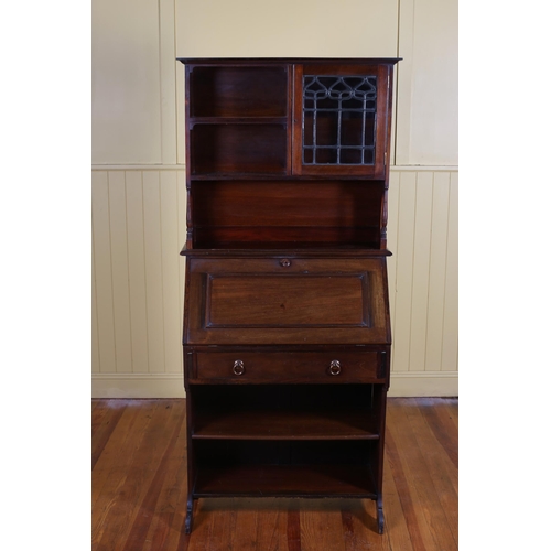 42 - AN ARTS AND CRAFTS MAHOGANY BUREAU BOOKCASE the superstructure with lead glass and clear glass cupbo... 