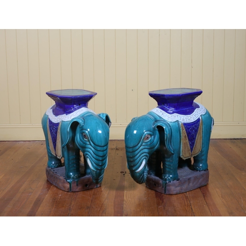 45 - A PAIR OF GLAZED TERRACOTTA ELEPHANT SEATS each decorated in turquoise, flow blue, white and topaz g... 