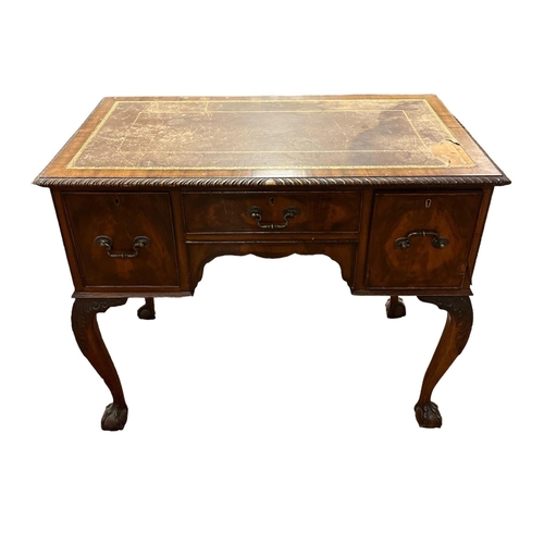 110 - A CHIPPENDALE STYLE MAHOGANY WRITING DESK with tooled leather inset above three frieze drawers on ca... 