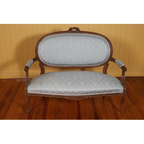 209 - A CONTINENTAL CARVED WALNUT AND UPHOLSTERED SETTEE the oval upholstered back and seat with scroll ar... 