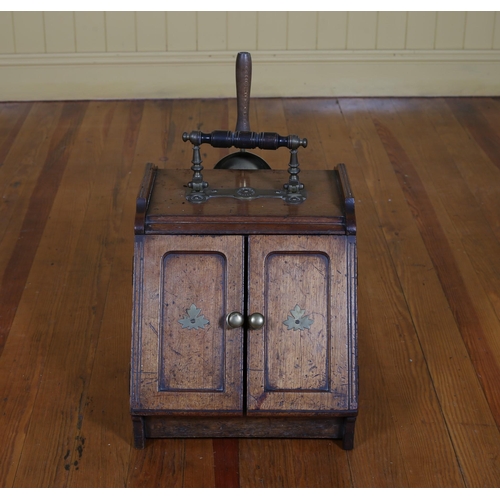 270 - AN EDWARDIAN MAHOGANY AND BRASS MOUNTED SLOPE FRONT FUEL BIN the hinged doors containing a zinc line... 