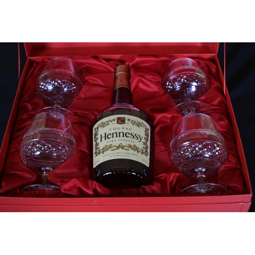 464 - A BOTTLE OF HENNESSY COGNAC Very Special Brandy in presentation case with four cut glass brandy glas... 