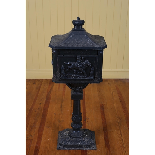 101 - A CAST IRON GREEN PAINTED FREESTANDING POSTBOX raised on a fluted baluster column on platform base 1... 