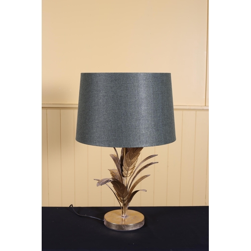 137 - A CONTEMPORARY GILT METAL TABLE LAMP the foliage column above a circular foot with shade 68cm (h)