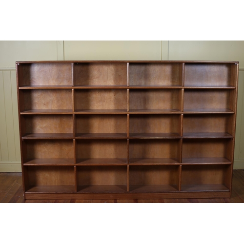 16 - A VINTAGE MAHOGANY OPEN FRONT BOOKSHELF of rectangular outline the shaped top containing twenty open... 