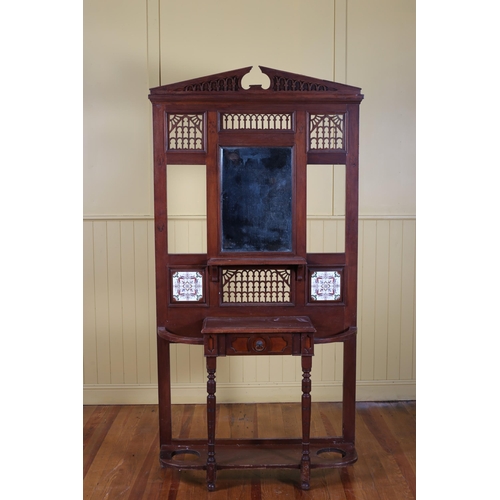 181 - A VINTAGE MAHOGANY HALL STAND the architectural pediment above a bevelled glass mirror with tiled in... 