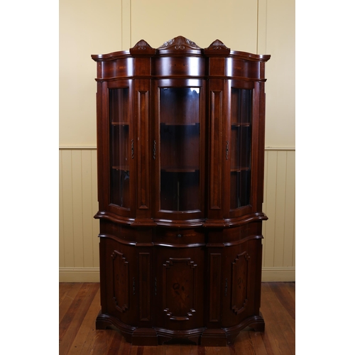 187 - A CONTINENTAL CHERRYWOOD INLAID DISPLAY CABINET of rectangular bowed outline with glazed doors conta... 