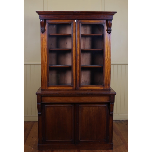 188 - A 19TH CENTURY MAHOGANY TWO DOOR LIBRARY BOOKCASE the moulded cornice above a pair of glazed doors c... 