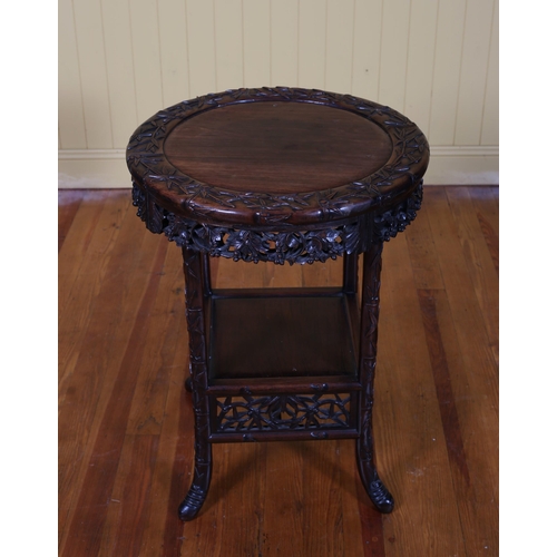 195 - A CHINESE CARVED ROSEWOOD OCCASIONAL TABLE the circular top with carved apron on splayed legs joined... 