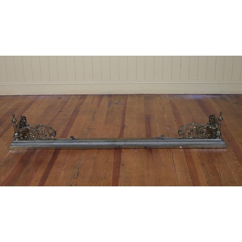 197 - A 19TH CENTURY BRASS FENDER the gadrooned platform with pierced C-scroll and foliate brackets to the... 