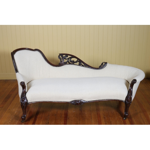 235 - A VICTORIAN CARVED MAHOGANY AND UPHOLSTERED SETTEE the pierced foliate carved top rail above an upho... 