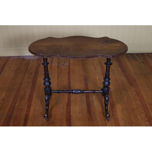 579 - A VICTORIAN MAHOGANY OCCASIONAL TABLE of serpentine outline the shaped top raised on baluster suppor... 