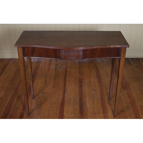 246 - A HEPPLEWHITE STYLE MAHOGANY SIDE TABLE of serpentine outline the shaped top with carved frieze on s... 