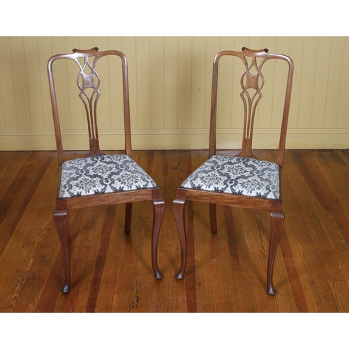 247 - A PAIR OF VINTAGE MAHOGANY AND UPHOLSTERED SIDE CHAIRS each with a scroll top rail and pierced verti... 