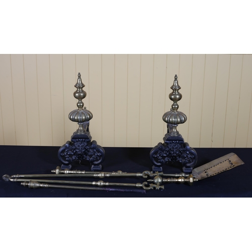 320 - A PAIR OF VINTAGE CAST IRON AND BRASS FIRE IRONS each with a knopped finial above a lion mask pierce... 