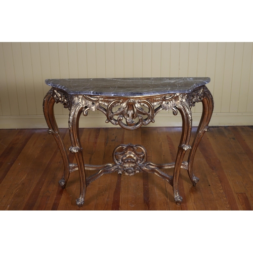 342 - A CONTINENTAL CARVED GILTWOOD CONSOLE TABLE of serpentine outline surmounted by a veined marble top ... 