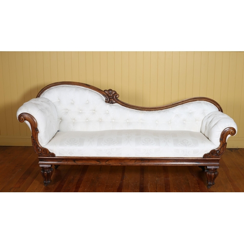 348 - A 19TH CENTURY CARVED ROSEWOOD AND UPHOLSTERED CHAISE LONGUE the serpentine top rail above a buttone... 