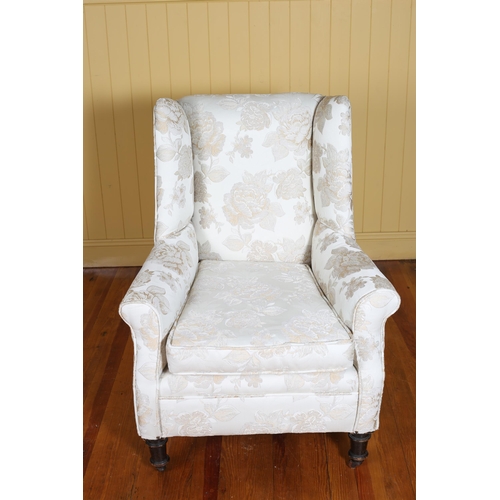 354 - A VINTAGE MAHOGANY AND UPHOLSTERED WING CHAIR with loose cushion on turned legs