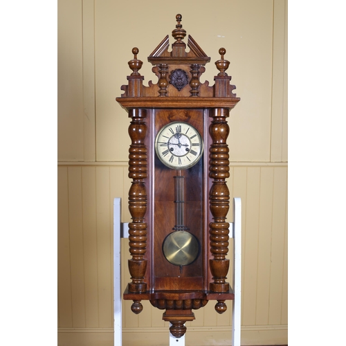 370 - A VINTAGE MAHOGANY CASED VIENNA WALL CLOCK with urn and shell cresting above a glazed door the dial ... 