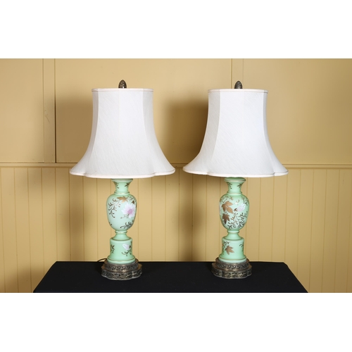 371 - A PAIR OF CONTINENTAL GREEN PORCELAIN AND GILT BRASS TABLE LAMPS each of bulbous form the green grou... 