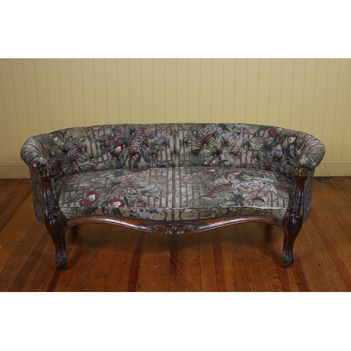 38 - A 19TH CENTURY CARVED MAHOGANY AND UPHOLSTERED SETTEE the deep buttoned curved upholstered back and ... 