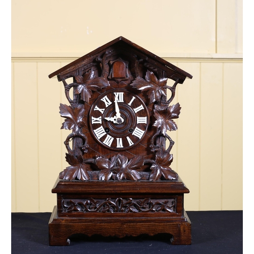 383 - A BLACK FOREST STYLE CARVED WOOD CUCKOO CLOCK the rectangular arched case with Roman numerals with f... 