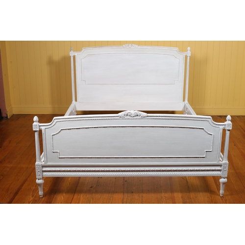 39 - A CONTINENTAL WHITE PAINTED BED the rectangular arched headboard with foliate C-scroll cresting betw... 