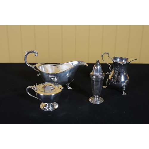 472 - A SILVER CREAM JUG, a silver sauce boat, mustard pot and pepper pot (4)