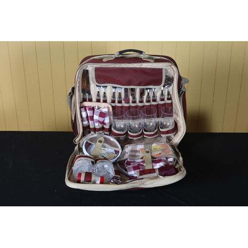 484 - A VINTAGE PICNIC SET in case containing cutlery, glasses, Tupperware, accessories, etc.