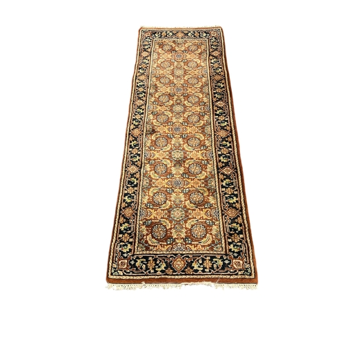 521 - A HERATI WOOL RUNNER the light brown, fawn and indigo ground with central panel filled with stylised... 