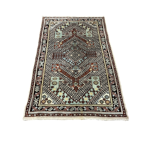 524 - A TURKISH TRIBAL RUG the multicolour ground with central geometric panel with palmettes and hooks wi... 