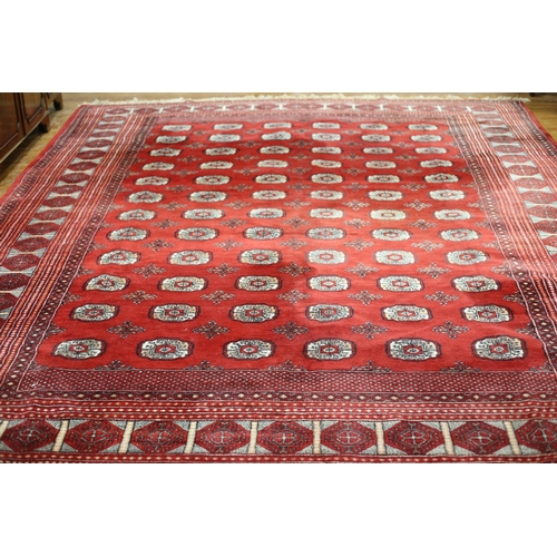 62 - A BOKHARA WOOL RUG the wine ground with central panel filled with palmettes within a conforming bord... 