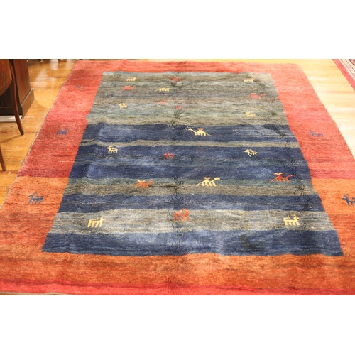 64 - A MOROCCAN GABBEH WOOL RUG the blue and wine ground filled with stylised animals 276cm (l) x 200cm (... 