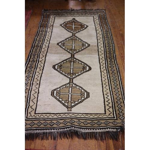 65 - A CAUCUS WOOL RUNNER the beige ground with central diamond shaped panels within a conforming border ... 