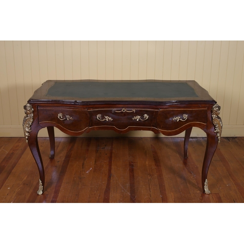 68 - A CONTINENTAL KINGWOOD INLAID AND GILT BRASS MOUNTED WRITING TABLE of serpentine outline the shaped ... 