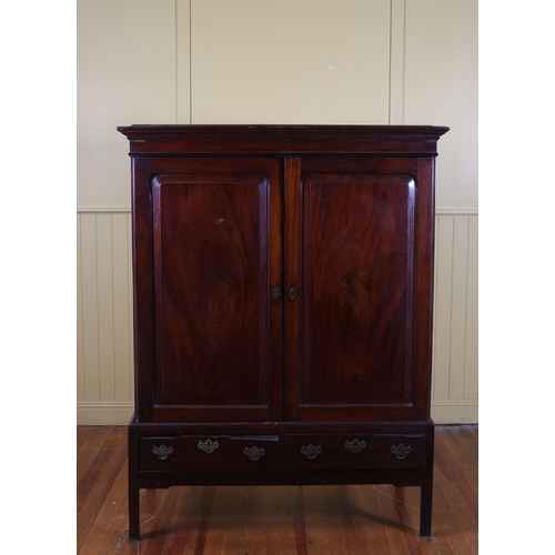 75 - A GEORGIAN MAHOGANY LINEN PRESS ON STAND the raised panel doors containing four shelves above two sh... 