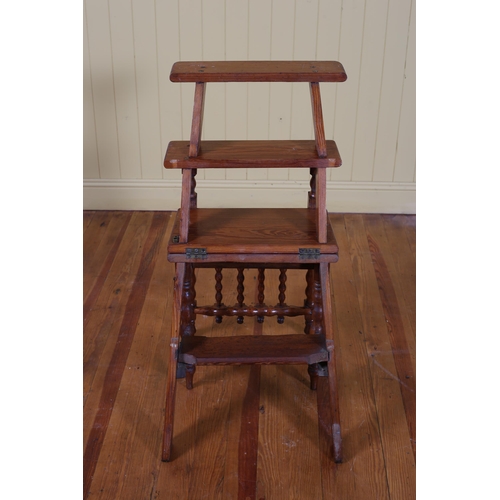 79 - A VINTAGE PITCH PINE METAMORPHIC LIBRARY STEPS with knopped splats and hinged seat on knopped and tu... 